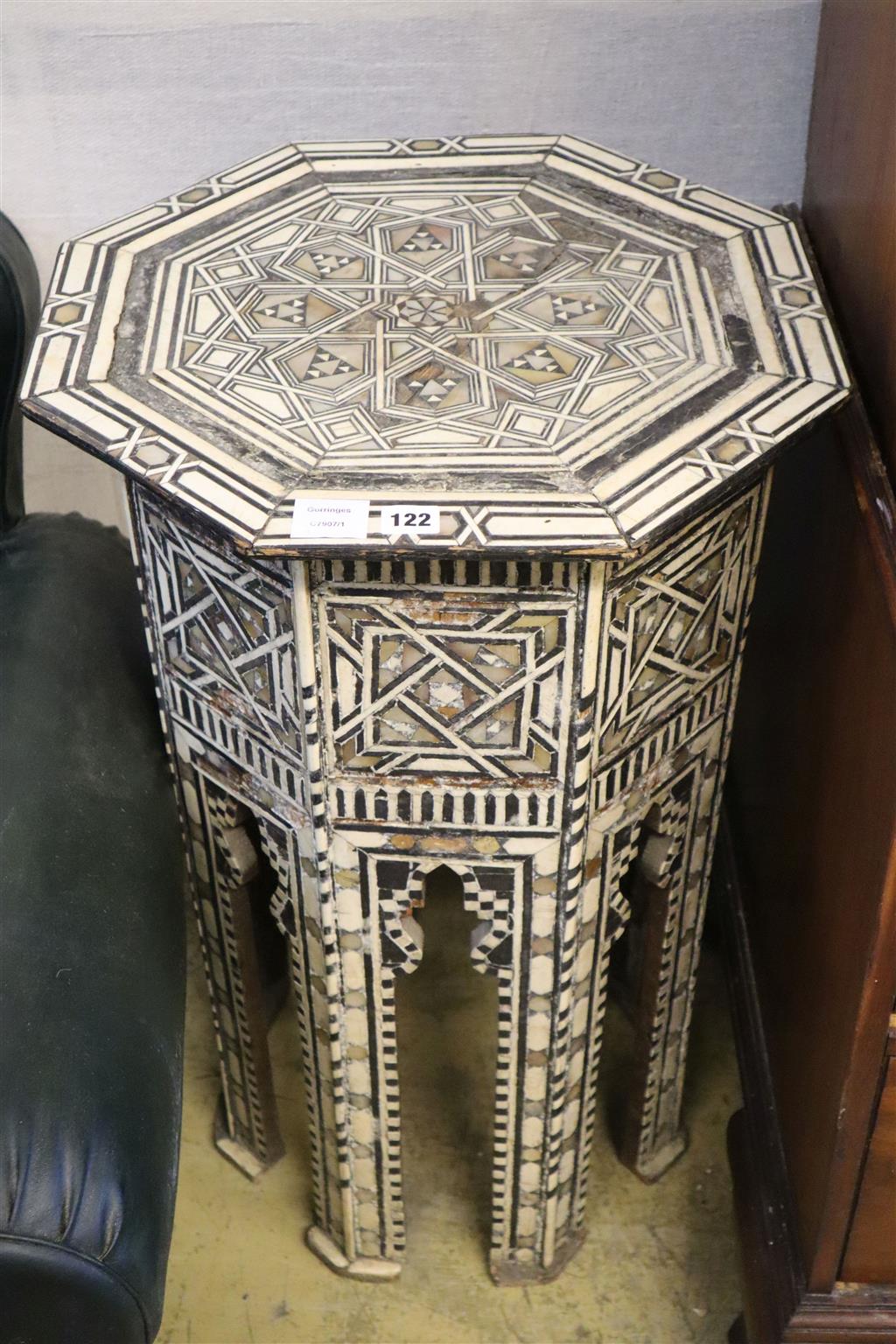 A Middle Eastern octagonal topped ebony and bone inlaid coffee table (damaged), width 49cm, 81cm high
